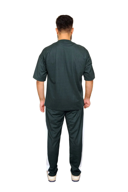 Man wearing black casual t-shirt and black pants with white side stripes, standing back