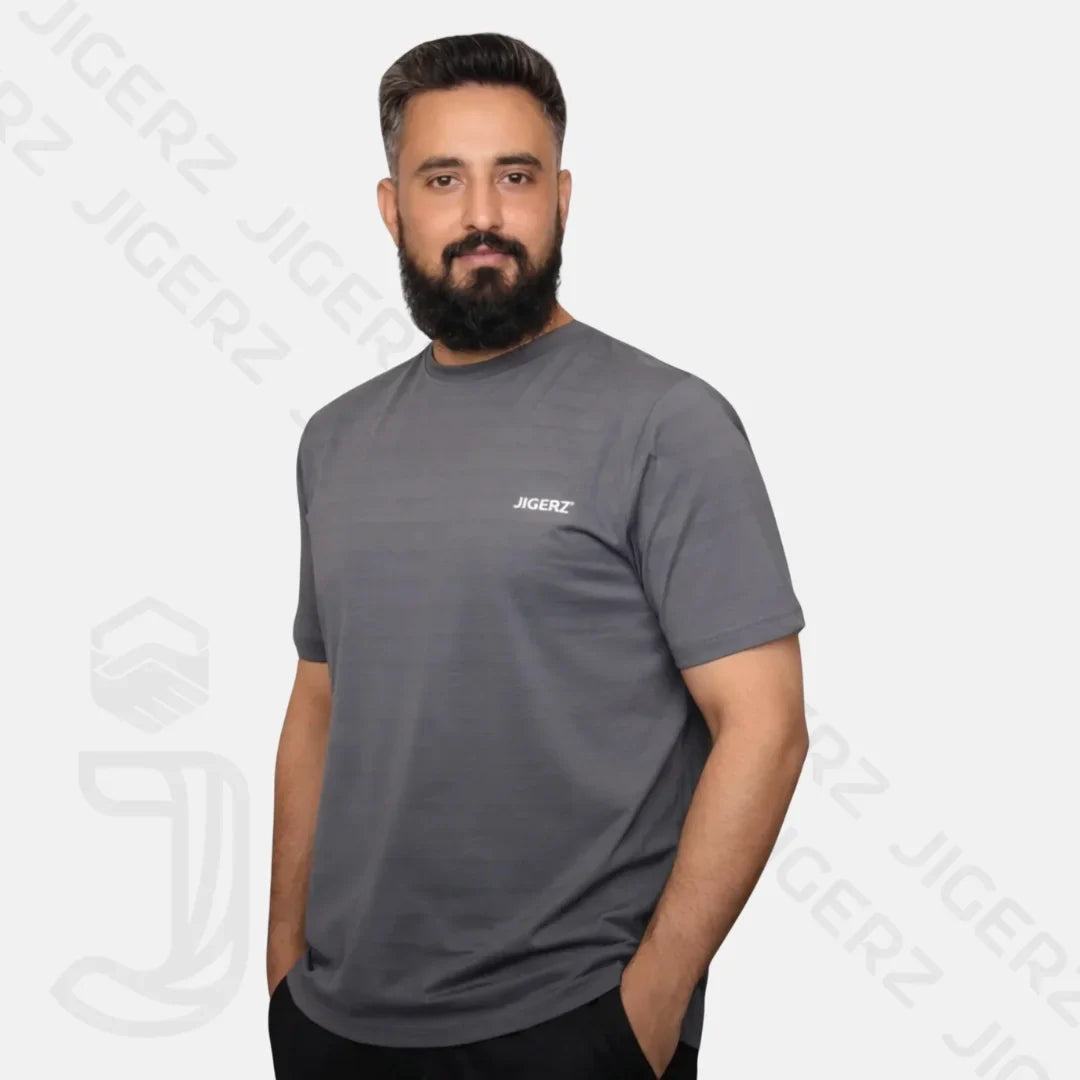 Man with beard wearing a white Jigerz branded t-shirt against a light blue background