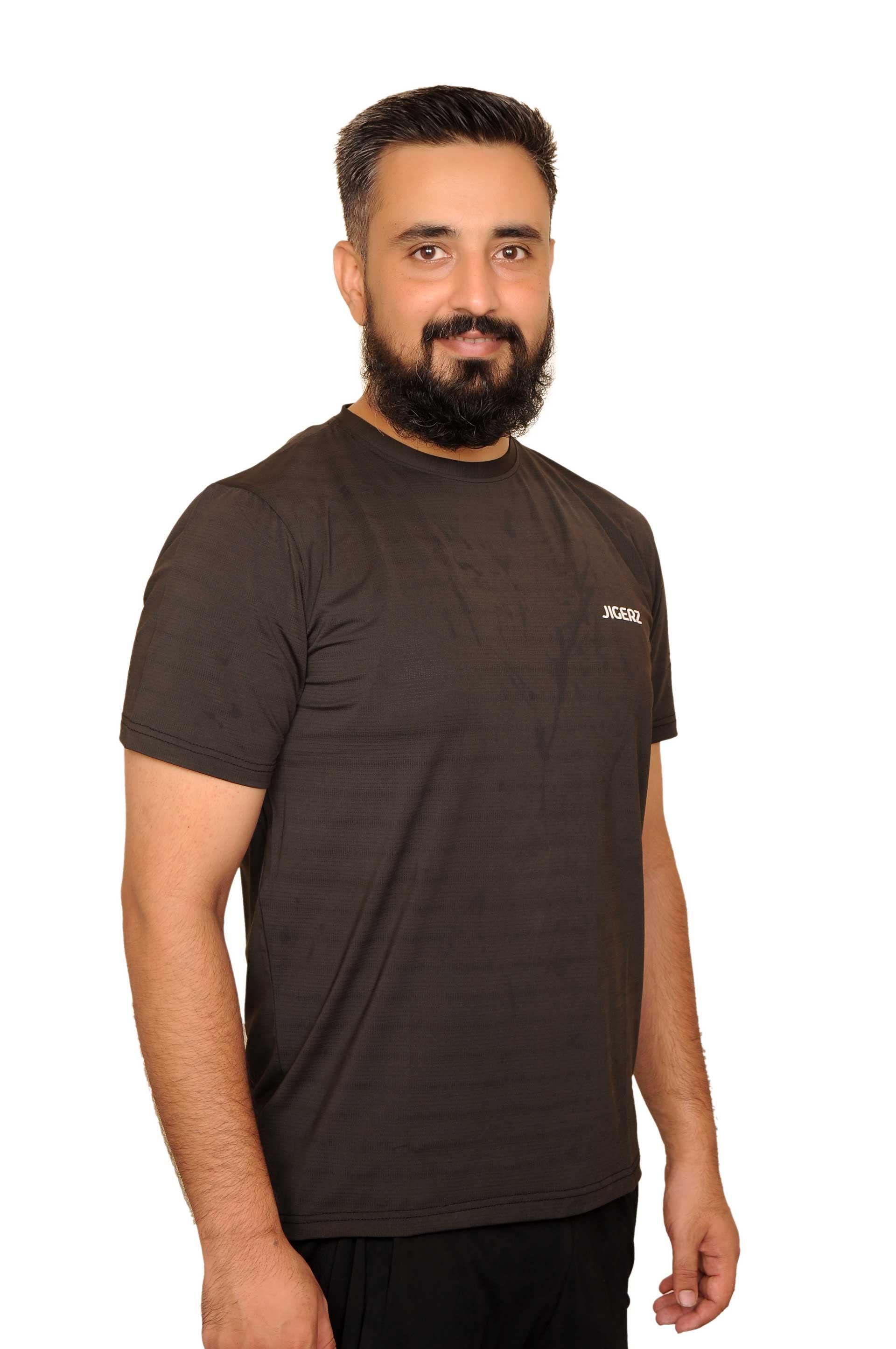 Smiling man with beard wearing black JIGERZ t-shirt against white background