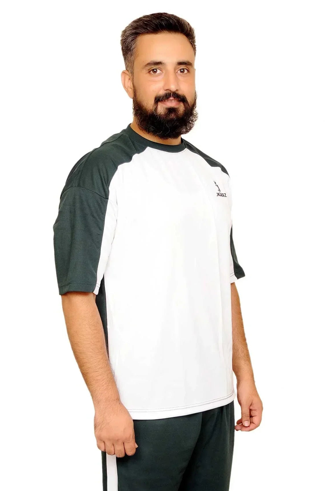 Man wearing black and white sportswear with sneakers standing on white background