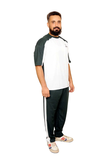 Man wearing black and white sportswear with sneakers standing on white background