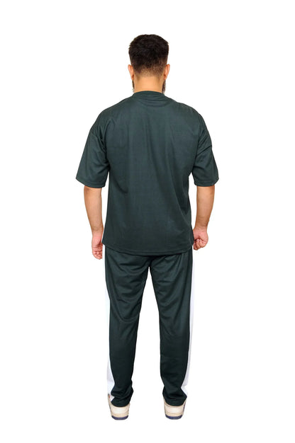 Man wearing black casual t-shirt and black pants with white side stripes, standing back