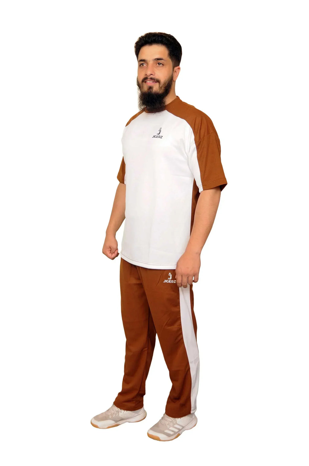 Man wearing brown and white Jigerz sportswear outfit with white sneakers on white background