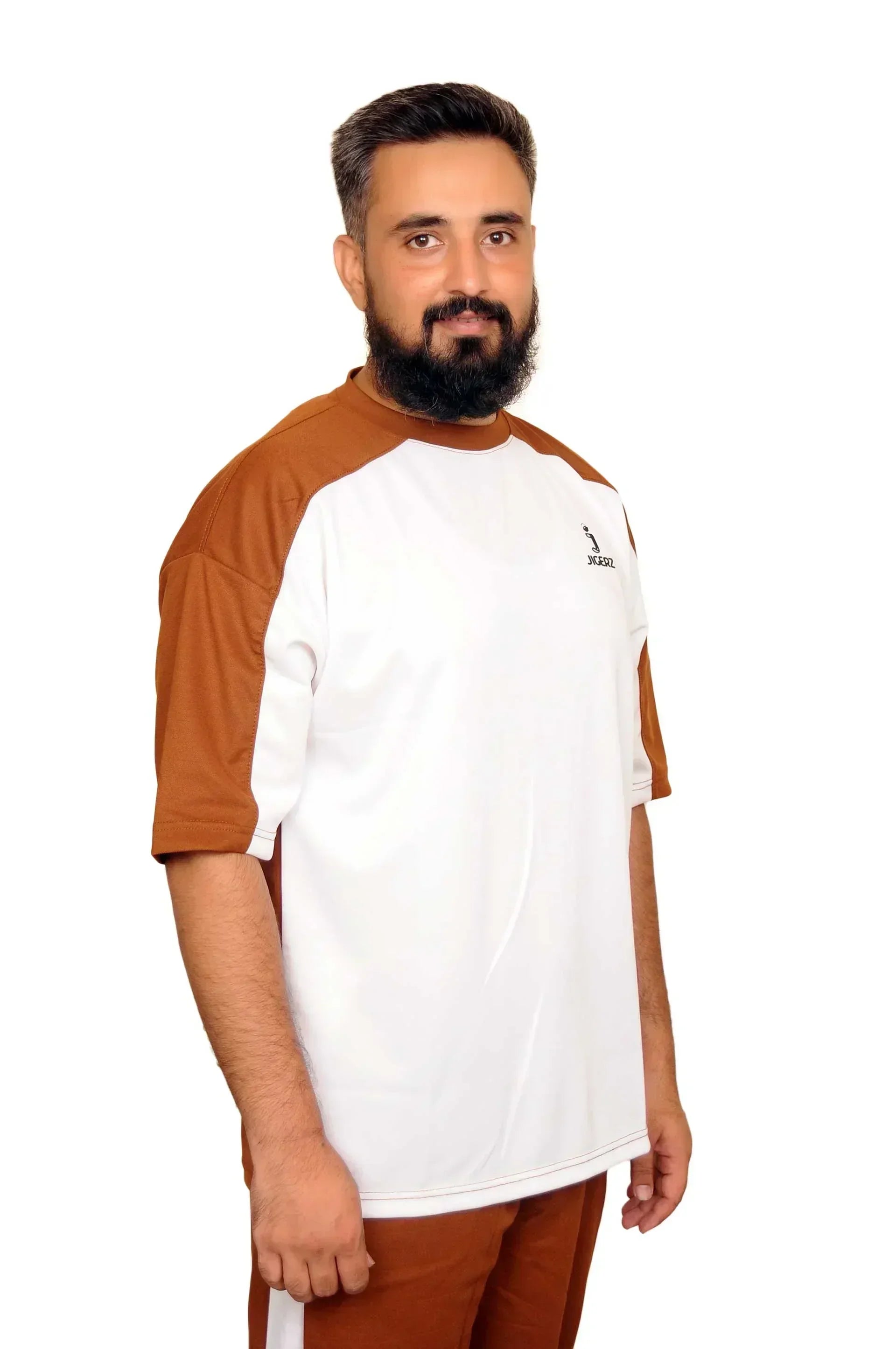 Man wearing brown and white JIGERZ sportswear with short sleeves posing against white background