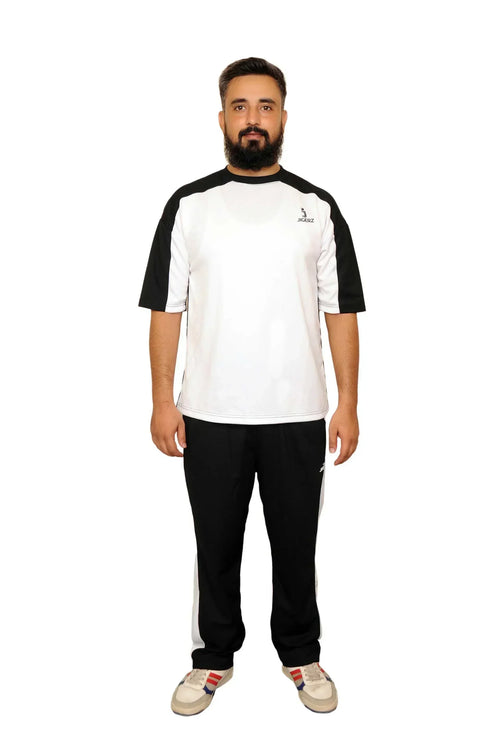 Man with beard wearing black and white Jigerz sportswear T-shirt and black track pants with sneakers