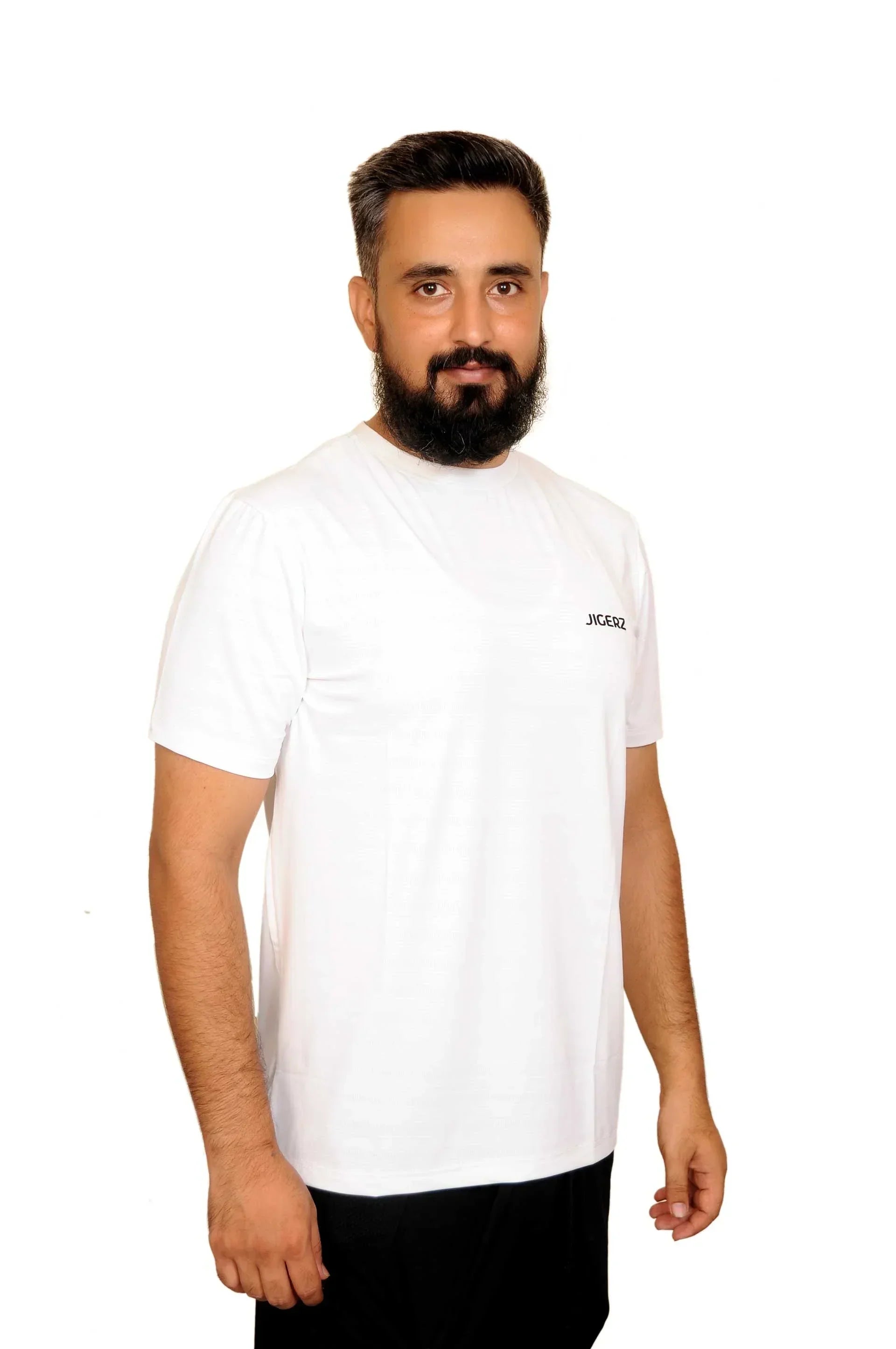 Bearded man wearing a white JIGERZ branded t-shirt against a white background