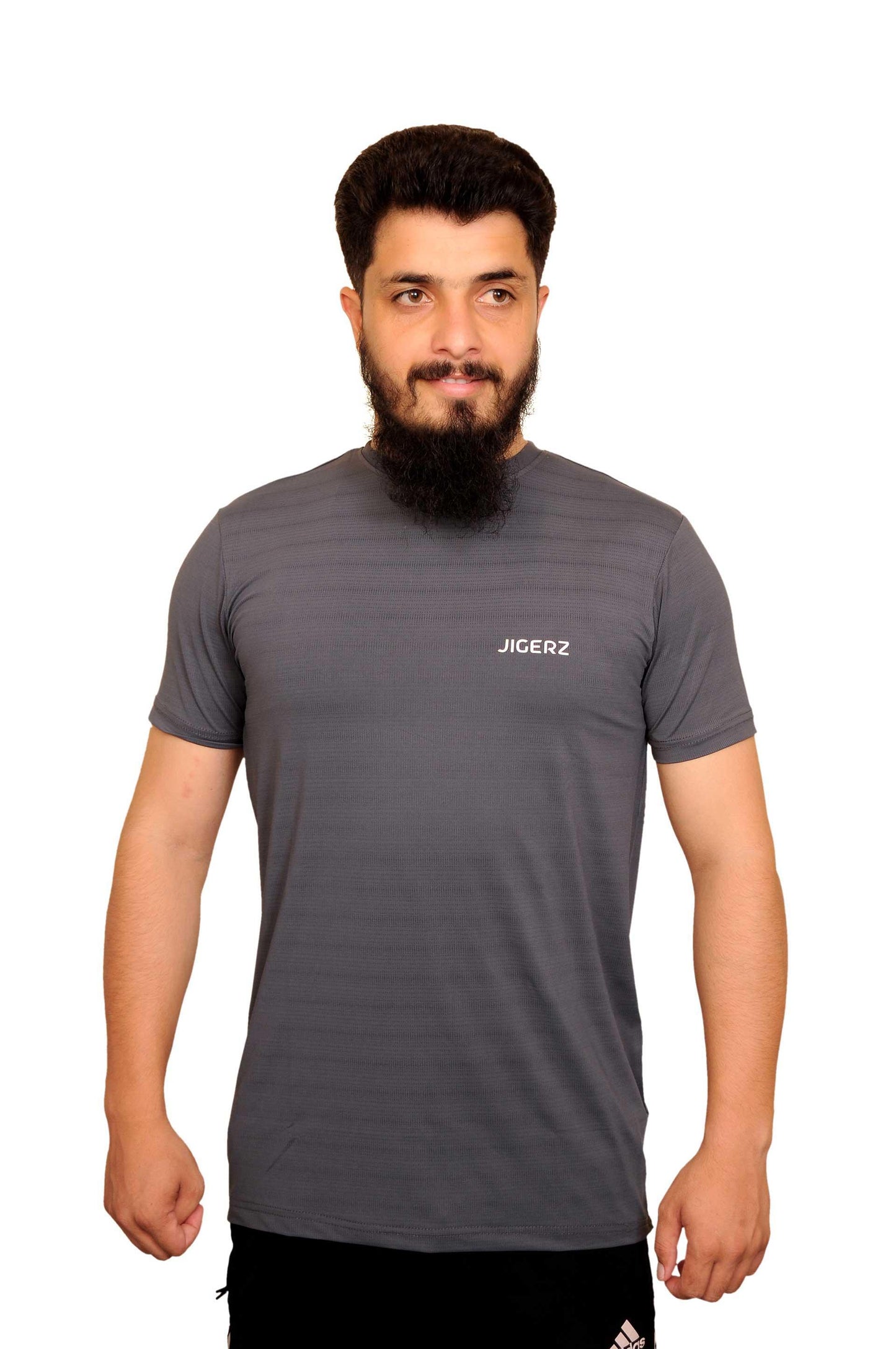 Man with beard wearing grey Jigerz branded athletic t-shirt and black Adidas shorts