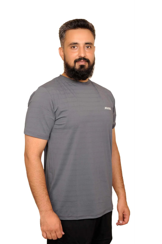 Bearded man wearing a gray Jigerz branded t-shirt against a white background