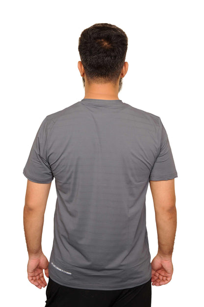 Man wearing plain gray short-sleeve athletic T-shirt standing with back to camera on white background