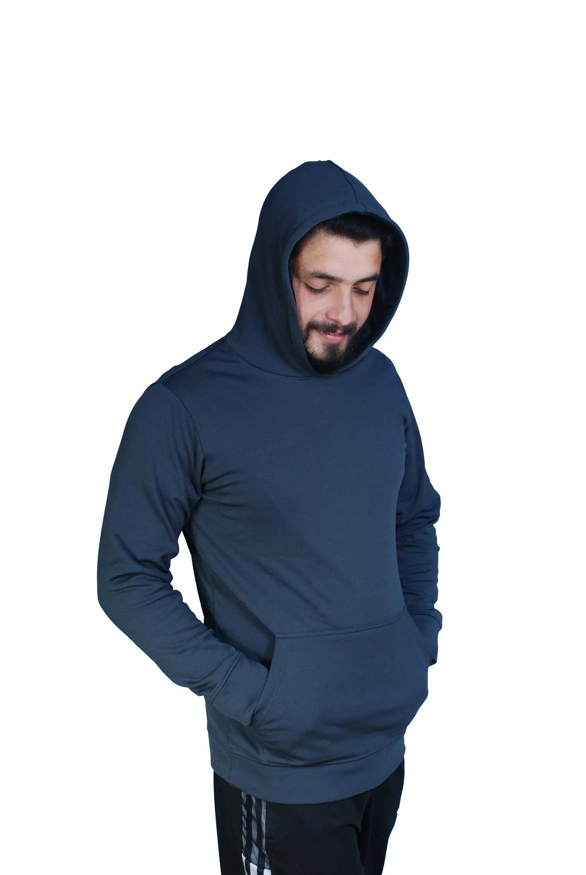 Man wearing dark blue hoodie with front pocket, hands in pockets, looking down, isolated on white